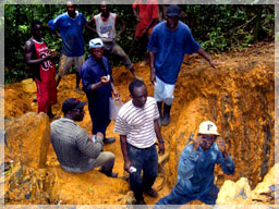 Geologists sampling hard rock mining pit / Kanyala