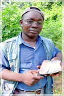 George Ahinikwah PGeo (former Sr Exploration Geologist for Ashanti) with intrusive quartz sample / Putu Mtn