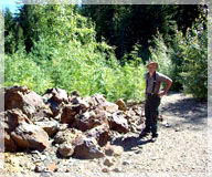 Prospector Horst Klassen by one of the large boulder piles / Skillet Creek